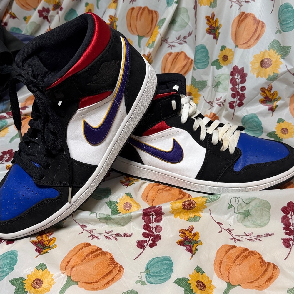 This is a pair of Nike Air Jordan 1 Mid "Bred Shadow" sneakers.